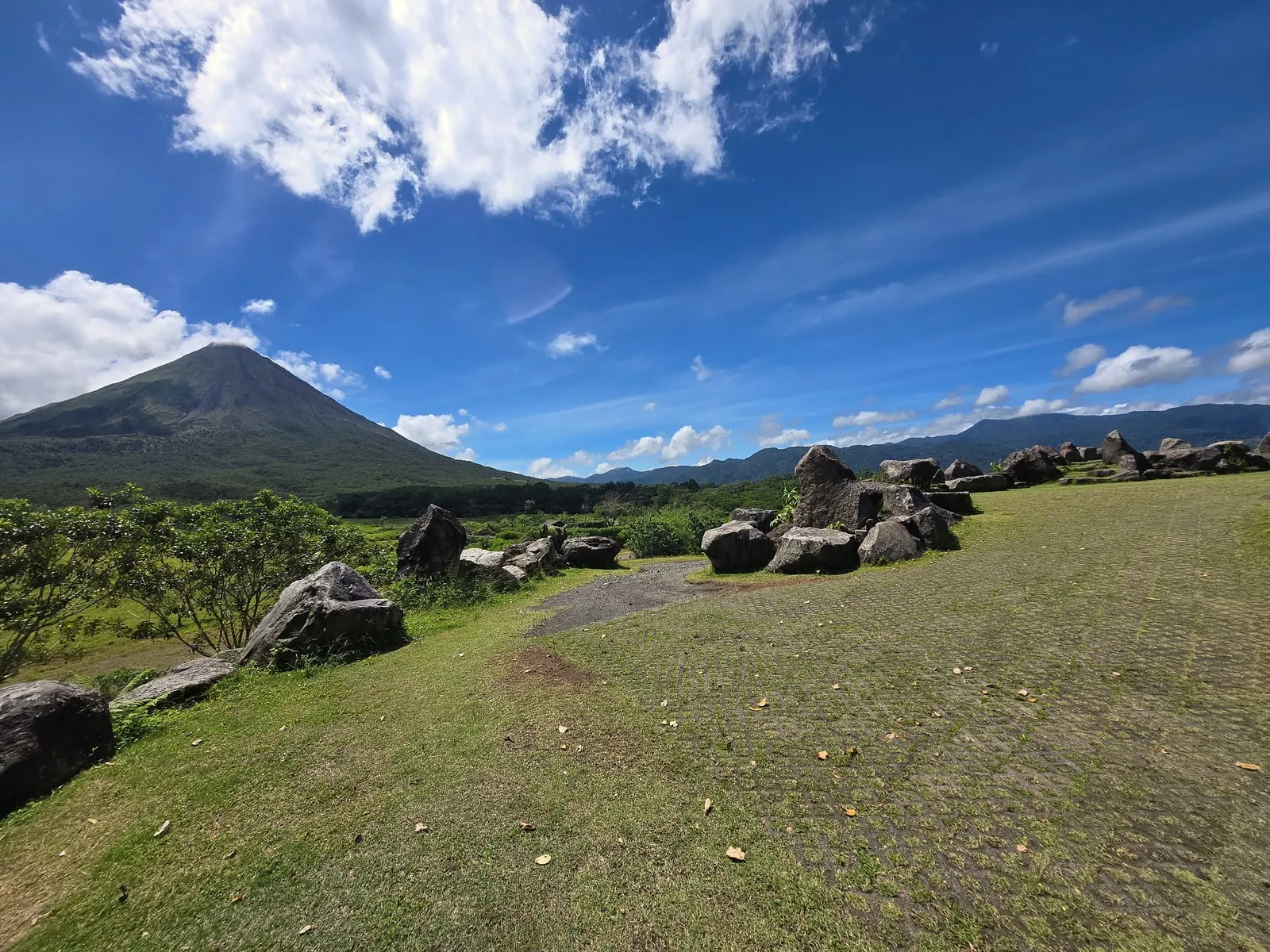 Arenal Volcano rising over green fields in Costa Rica